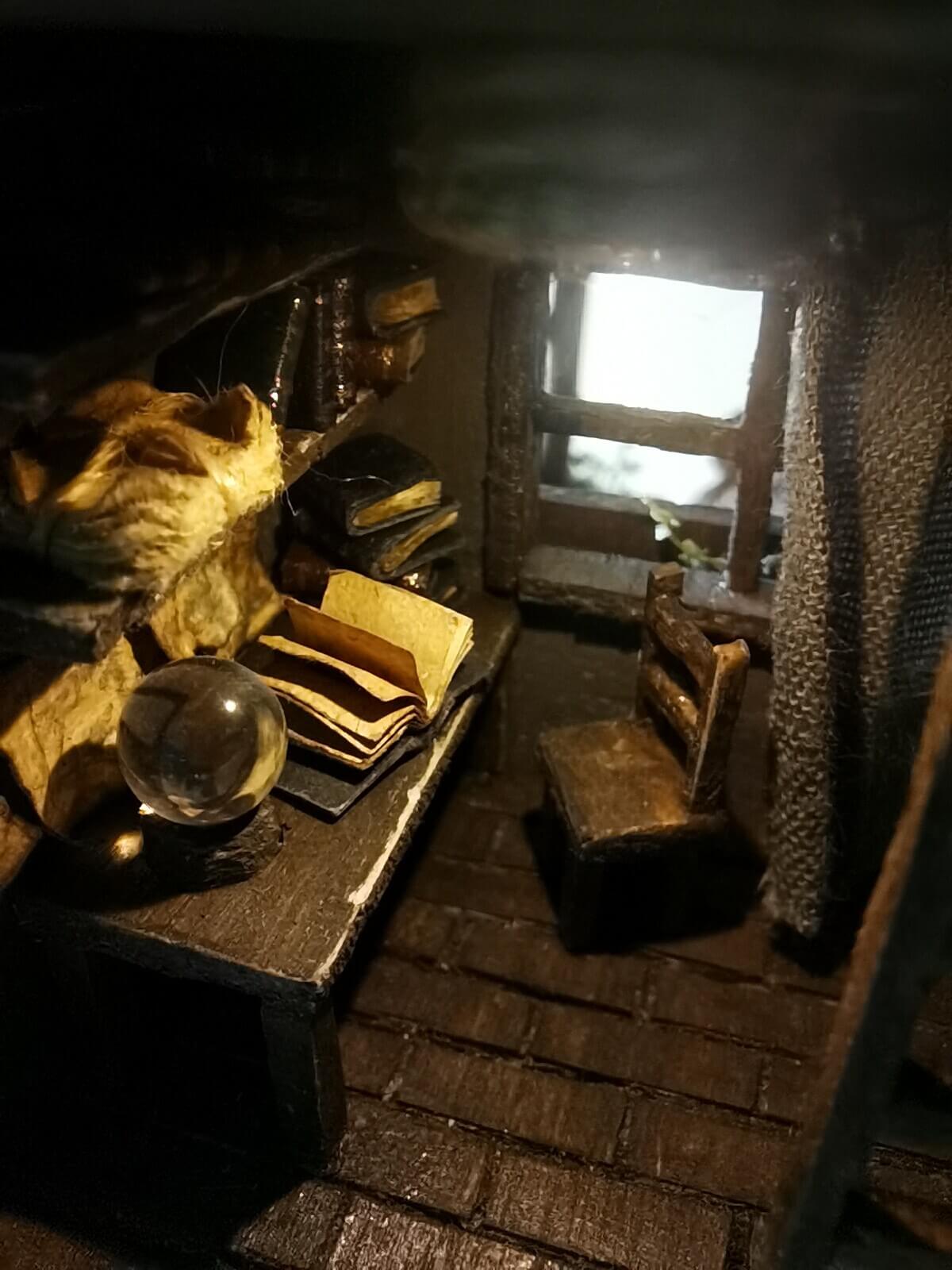 This miniature wooden treehouse exudes a whimsical, fairy-tale charm. It features a cozy loft bed under a slanted roof, accessible by a rustic wooden ladder. Warm lighting illuminates the intricate interior details, including a tiny desk, books, and woven fabrics, showcasing the delicate craftsmanship and magical ambiance of this enchanting creation.