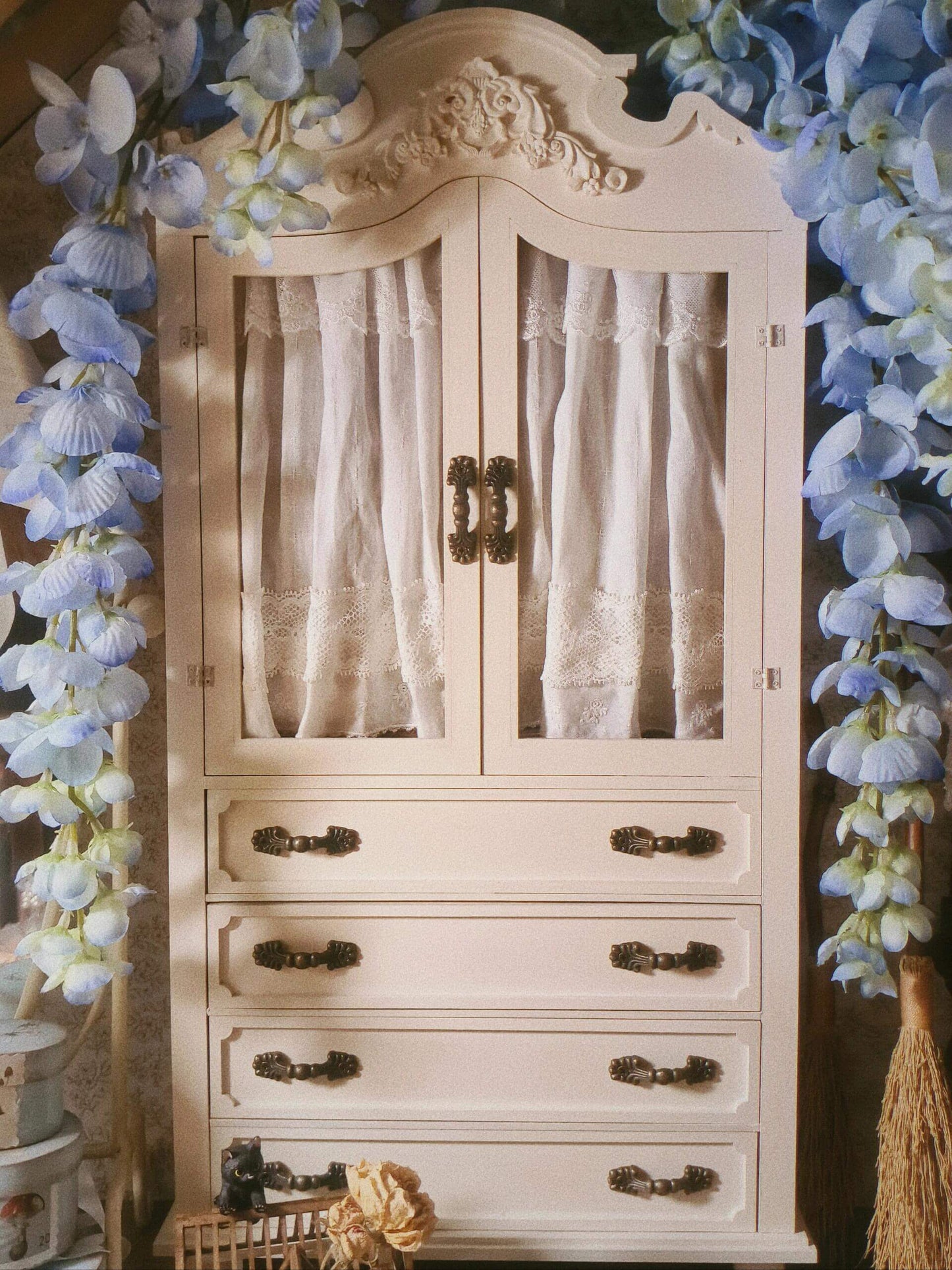 Add a vintage touch to your dollhouse kitchen with this Miniature Vintage Kitchen Cabinet Carved Cupboard with Doors and Drawers. This beautifully crafted cabinet features intricate carvings, doors for concealed storage, and drawers for organizing small items. The charming design and detailed craftsmanship make it a perfect addition to any miniature kitchen, offering both functionality and style.