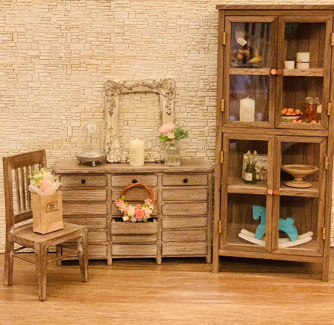 Created with versatility in mind, this display shelf and bookcase may be used in the dollhouse kitchen as a cabinet, in the study as a bookcase or in the living room as a bookcase or display cabinet. Color/ Finish: Cherry wood or Dark walnut