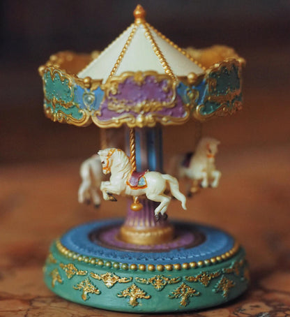 Add a touch of nostalgia to your dollhouse with this vintage-style miniature carousel with beautiful horses. Its vibrant colours and traditional style will be a striking and eye-catching addition to any dollhouse. Height: 6cm / 2.36inches