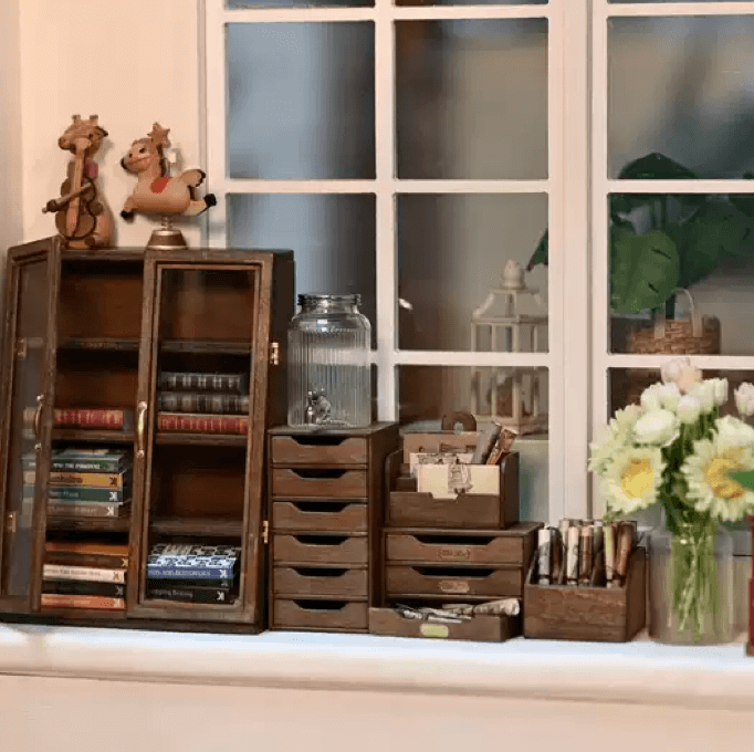 The Miniature Wooden Dollhouse Storage Shelf is a perfect addition to any dollhouse decor. It is designed to hold small cloth dolls and miniature study room scene decoration props. The exquisite design matches well with any room decoration style.