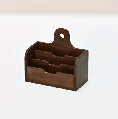 The Miniature Wooden Dollhouse Storage Shelf is a perfect addition to any dollhouse decor. It is designed to hold small cloth dolls and miniature study room scene decoration props. The exquisite design matches well with any room decoration style.