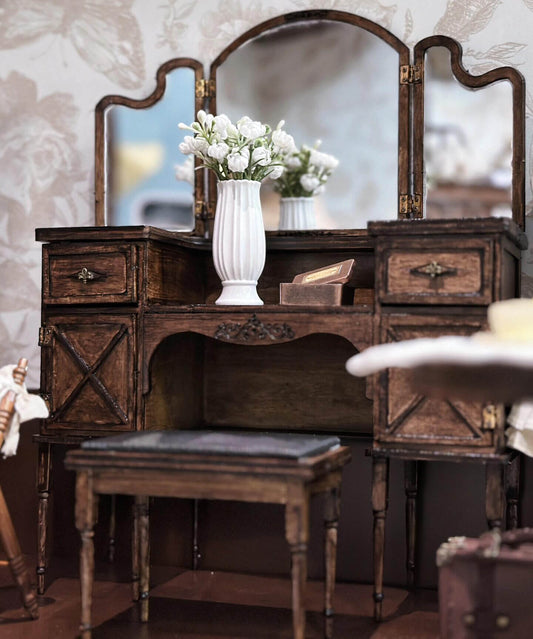 This miniature set includes a makeup table, a mirror, and a stool upholstered in faux leather, all meticulously handcrafted with attention to detail. The care and precision in this diorama furniture is evident in every piece, making this set a standout addition to any dollhouse bedroom or dressing area. 