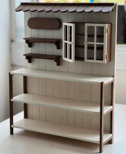 Add a charming touch of rustic elegance to your dollhouse with this Miniature Wooden Garden Shop Display Shelf Kit. Designed with intricate details, this piece features a classic garden shop look, complete with shelves for display and storage compartments. The roof adds a cozy, inviting feel, while the functional shelves are perfect for showcasing miniature plants, garden tools, and other tiny treasures.