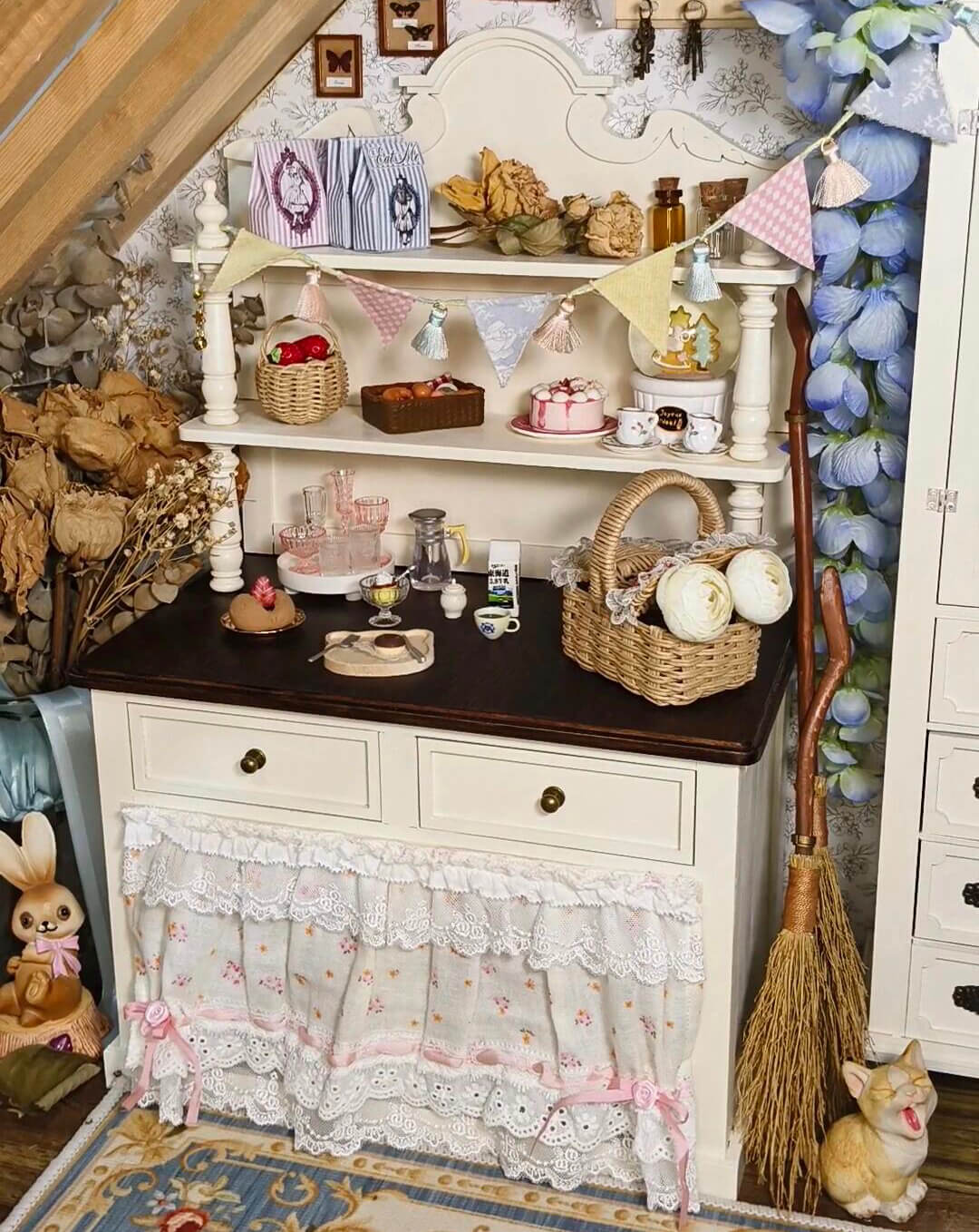 Bring rustic charm to your dollhouse kitchen with this Miniature Vintage Kitchen Hutch Cabinet Kit. This beautifully crafted kit includes a spacious upper shelf for displaying small items, along with a lower section featuring storage drawers and cupboards for organizing kitchen essentials. The charming white finish with intricate detailing and elegant design makes it a perfect addition to any miniature kitchen, dining room, or country-style space.