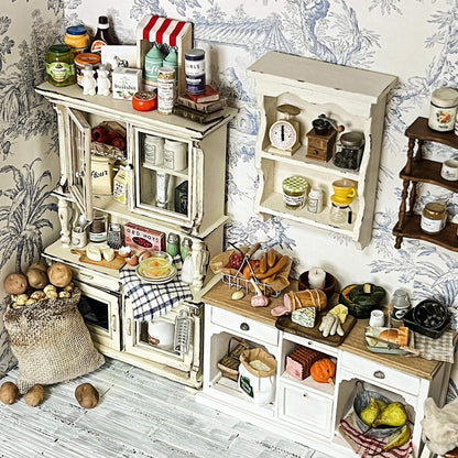 Add a touch of vintage elegance to your dollhouse with this Miniature Shabby Chic Kitchen Sideboard Cupboard Dresser Cabinet Kit. This beautifully crafted piece combines a charming sideboard with a cupboard and dresser, offering both display and storage options. The cabinet features doors for showcasing small items, while the lower section includes drawers for organizing your mini treasures.