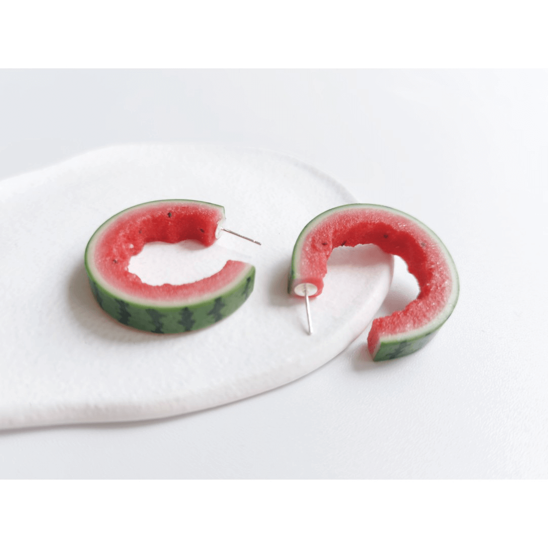 This listing is for 1 pair of C shaped watermelon stud earrings. Cute realistic watermelon stud earrings with sterling silver studs. The watermelon are made with polymer clay and then finished with a gloss varnish. The earrings are made from high-quality materials and are durable, but should not be put in aggressive environments like excessive moisture, chemicals or perfume.