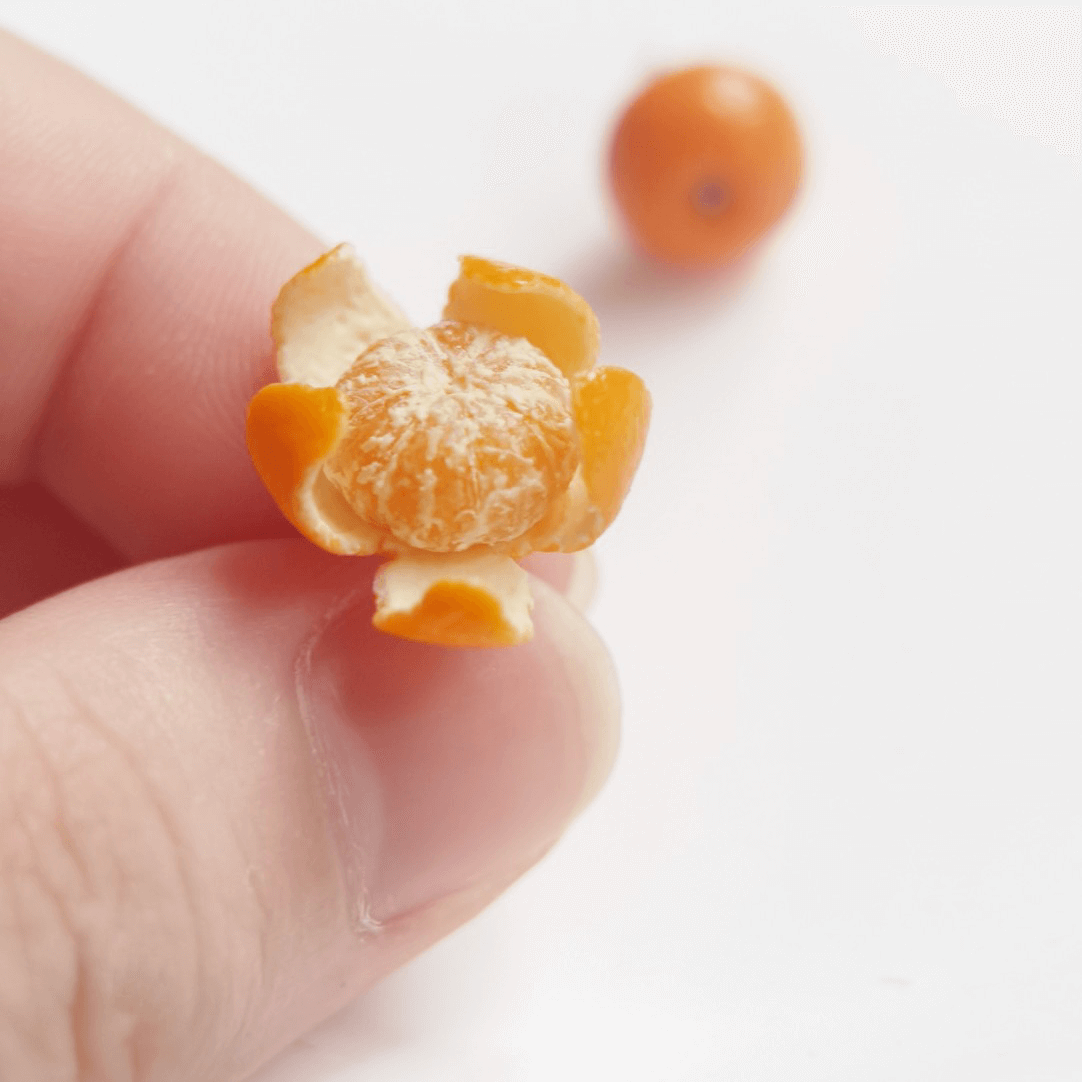 Cute realistic whole and peeled tangerine stud earrings with sterling silver studs. The tangerine are made with polymer clay and then finished with a gloss varnish. The earrings are made from high-quality materials and are durable, but should not be put in aggressive environments like excessive moisture, chemicals or perfume.