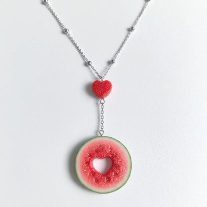 Cute realistic round watermelon slice with cut in the shape of heart necklace with sterling silver chain. The watermelon are made with polymer clay and then finished with a gloss varnish. The necklace are made from high-quality materials and are durable, but should not be put in aggressive environments like excessive moisture, chemicals or perfume.