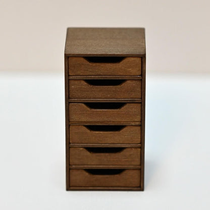 Maintain orderliness for your dollhouse office documents and materials using this Miniature Office Filing Cabinet. With a total of six drawers, you’ll have ample space to store and arrange your items systematically. Default Color/ Finish: Brown Style: Shabby Chic Material: Wood Scale: 1/6 (4×4×7.3cm / 1.58×1.58×2.87in)