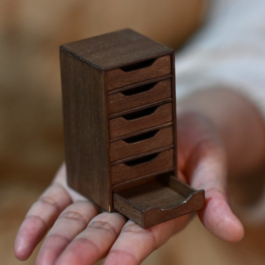 Maintain orderliness for your dollhouse office documents and materials using this Miniature Office Filing Cabinet. With a total of six drawers, you’ll have ample space to store and arrange your items systematically. Default Color/ Finish: Brown Style: Shabby Chic Material: Wood Scale: 1/6 (4×4×7.3cm / 1.58×1.58×2.87in)