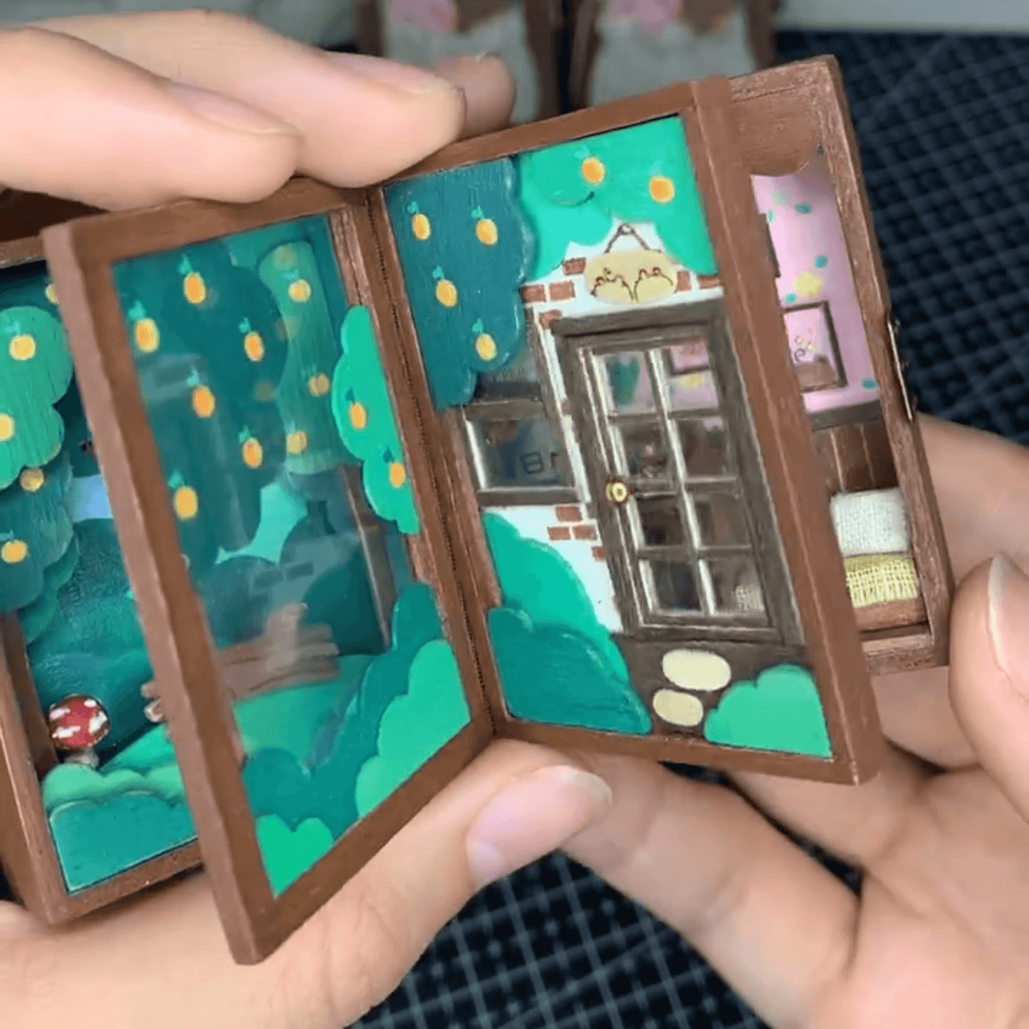 This flip book diorama showcases a beautifully crafted miniature scene featuring BB Bear's cozy home, presented in a flip book-style diorama. As the pages turn, the viewer is transported into a tiny, charming world where BB Bear lives. The intricate details of the miniature house, furnishings, and surroundings create a warm, inviting atmosphere.