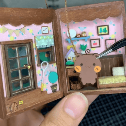 This flip book diorama showcases a beautifully crafted miniature scene featuring BB Bear's cozy home, presented in a flip book-style diorama. As the pages turn, the viewer is transported into a tiny, charming world where BB Bear lives. The intricate details of the miniature house, furnishings, and surroundings create a warm, inviting atmosphere.