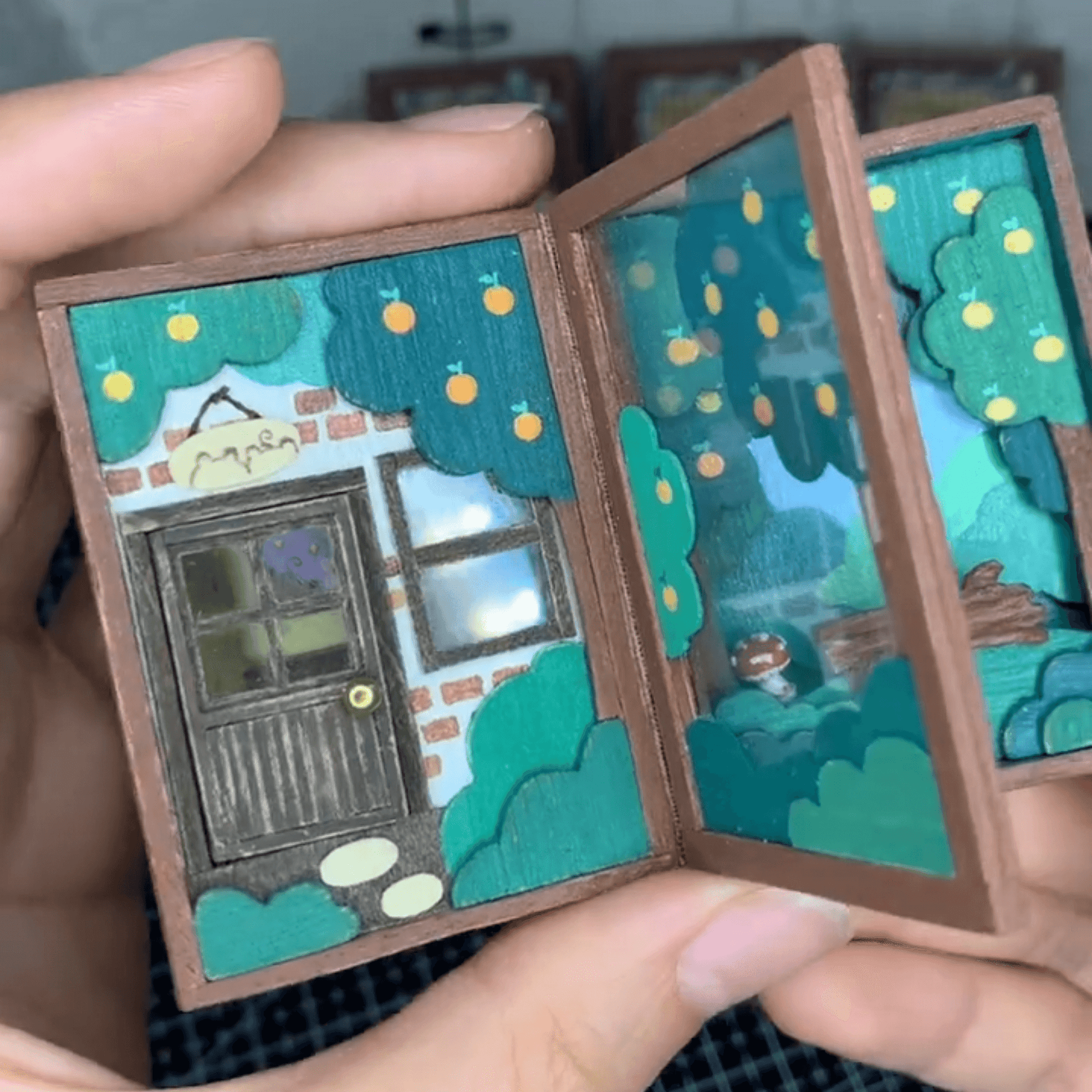 This flip book diorama showcases a delicate miniature scene of Bunny Kani's home, presented in a flip book-style diorama within a tiny craft world. The visuals are intricate and creative, with each page turn revealing a unique little world, as if drawing the viewer into Bunny Kani's cozy home.