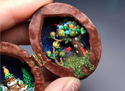 This enchanting miniature scene, set inside a walnut shell, depicts a festive christmas winter wonderland. Colorful ornaments, miniature snowdrifts, and delicate details like the Christmas tree on the castle create a magical holiday atmosphere. Perfect as a keepsake or holiday decoration, this miniature walnut shell diorama captures the essence of Christmas in a unique, handcrafted style.