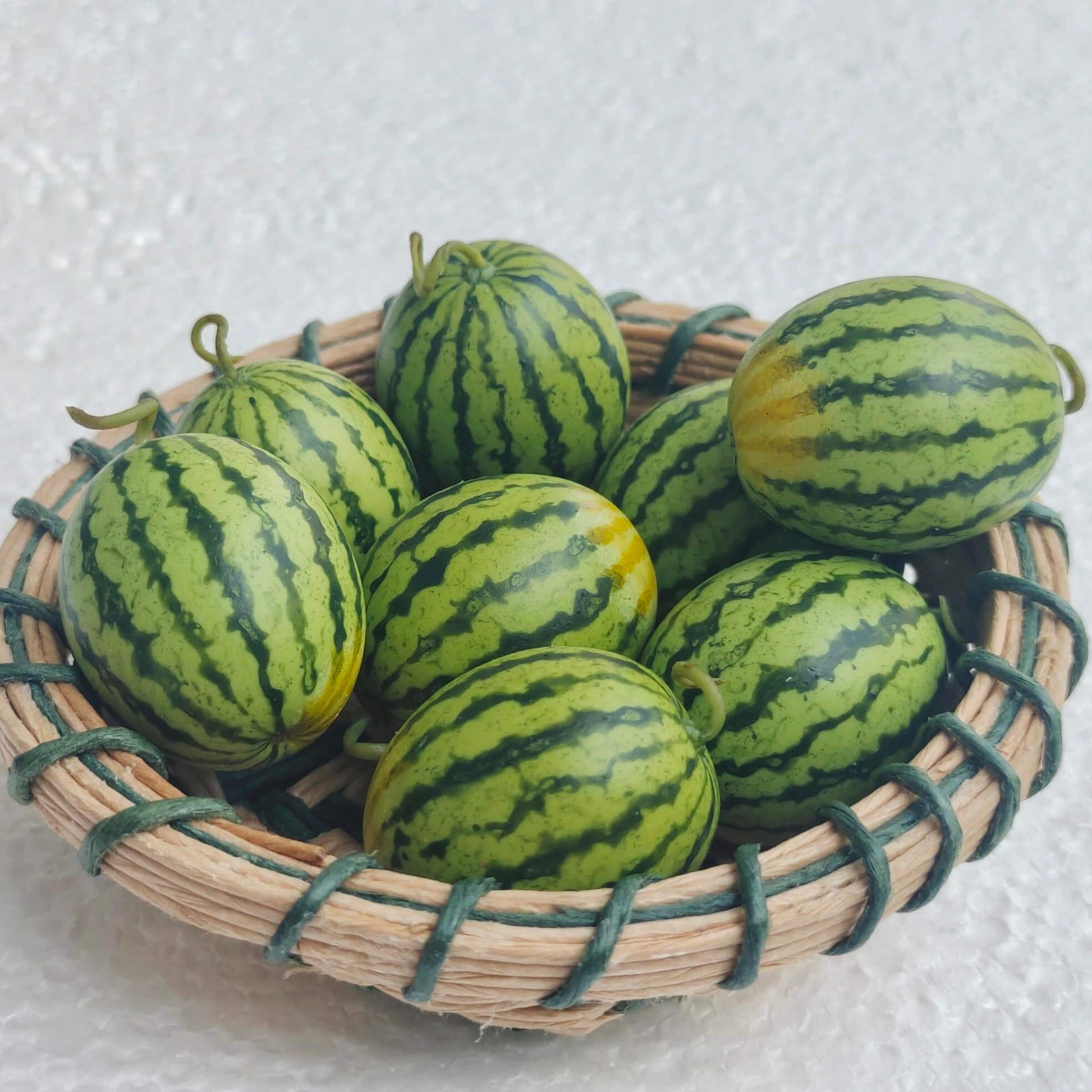 Enhance your dollhouse with these meticulously crafted miniature watermelons. These miniature watermelons are made with attention to detail, ensuring durability and a lifelike appearance. The intricate details and vibrant colors make them stand out as realistic and attractive dollhouse food items. Material: Clay