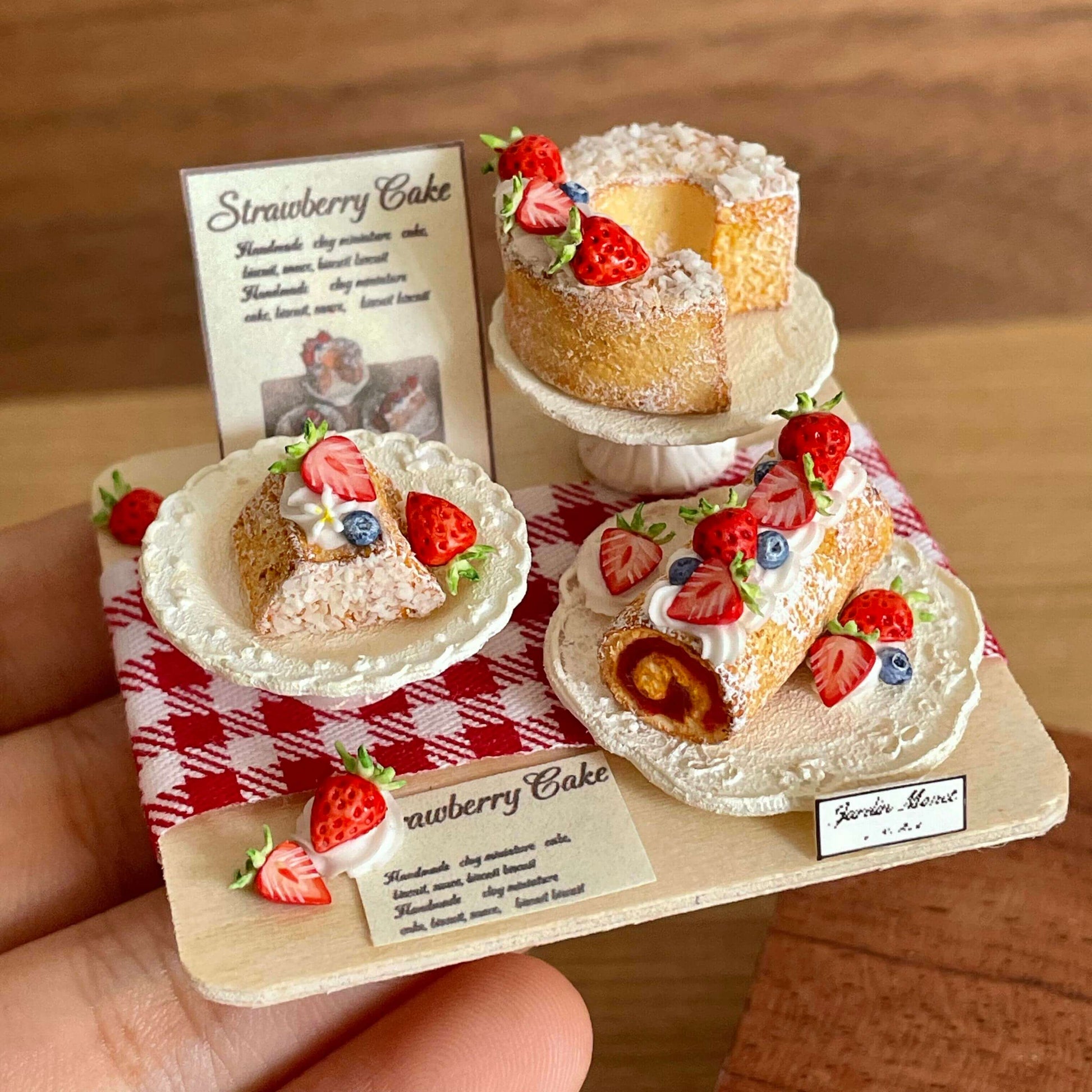 Indulge in our Miniature Strawberry Cake Set, a delightful addition to your dollhouse or miniature scene. All featuring a charming strawberry theme. Each piece is carefully made with high-quality materials to ensure realistic details and long-lasting beauty.