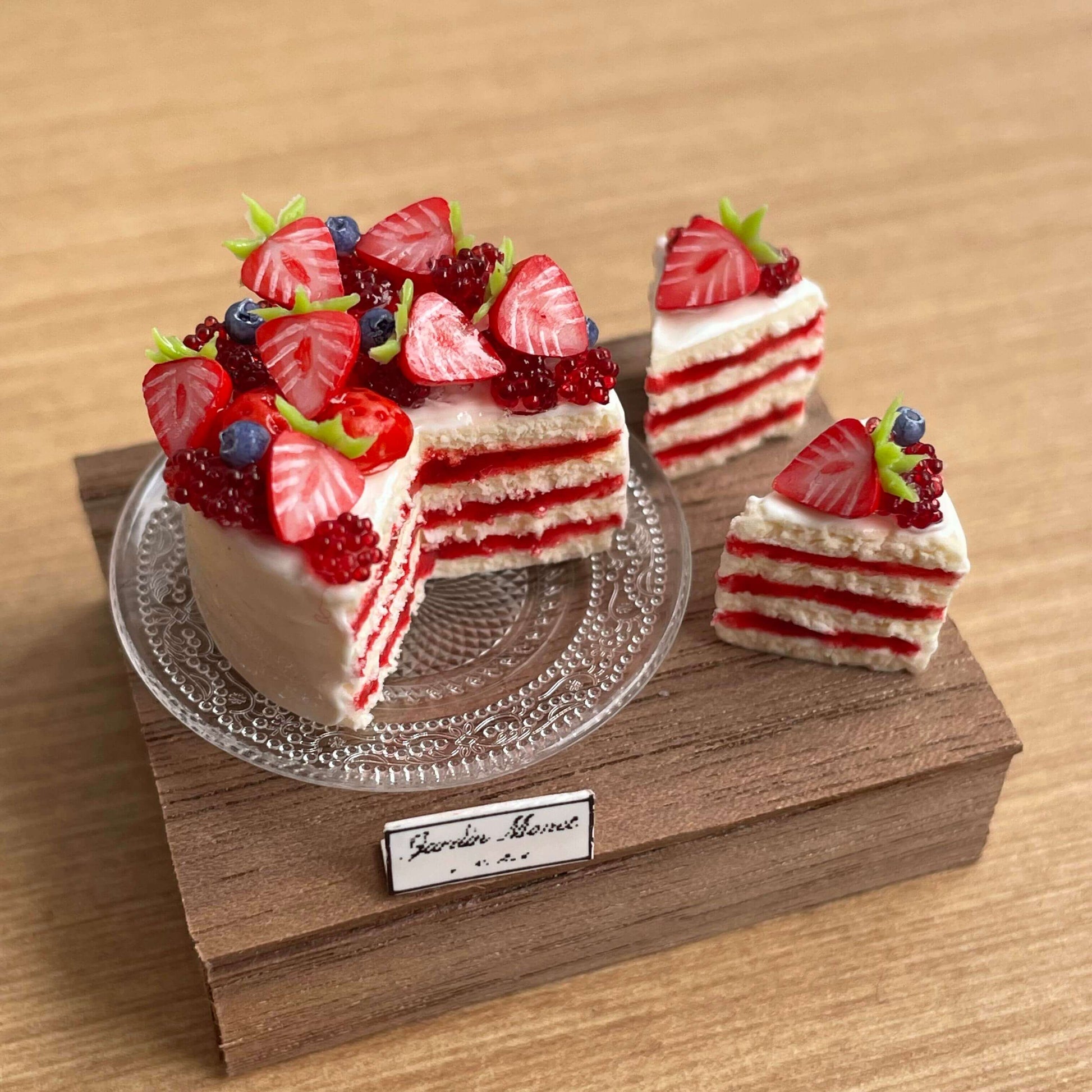 Indulge in our Strawberry and Berry Cake Set, a delightful addition to your dollhouse or miniature scene. All featuring a charming strawberry and berry theme. Each piece is carefully made with high-quality materials to ensure realistic details and long-lasting beauty.