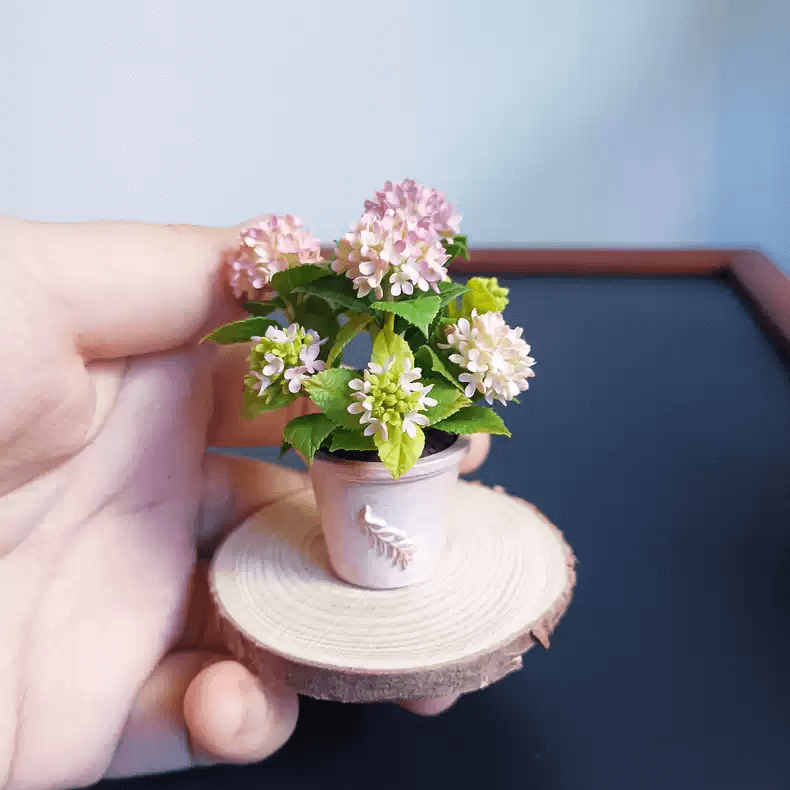 Hydrangeas are deciduous shrubs with flowers in terminal, round or umbrella-shaped clusters in colors of white, pink, or blue, or even purple. Dollhouse Garden Plants Handmade from Clay. Size: 6.5 cm/2.56inch tall plant in a 2.7 cm/1.06inch pot.