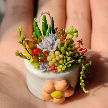 Succulents are a diverse group of plants known for their ability to store water in their leaves, stems, and roots. They are found in a wide range of shapes, sizes, and colors, making them popular choices for indoor and outdoor gardens. Material: Handmade from Clay