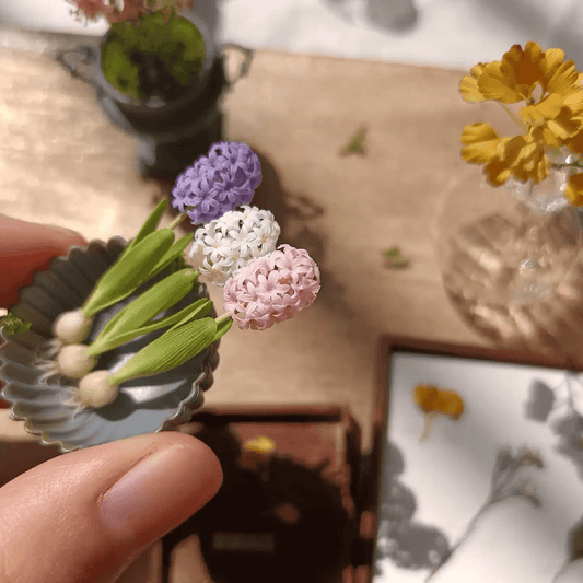 Dutch Hyacinth (Hyacinthus orientalis) bears purple, pink or white blooms throughout late March and early April. It has a rich fragrance.  Scale: 1:6; 1:12  Material: Handmade from Clay  Size: Standard; With bulb  Color: White; Pink; Purple