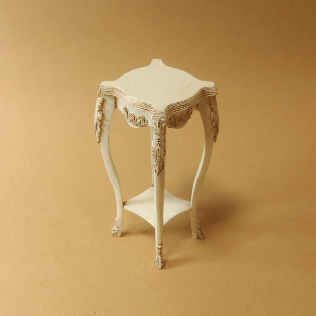 This Miniature Artisan Flower Stand Plant Shelf Side Table Kit for Dollhouses is a versatile and elegant addition to any dollhouse setting. Designed with intricate carvings and gracefully curved legs, this piece serves as a charming flower stand, a practical plant shelf, or a stylish side table. Its timeless vintage aesthetic makes it ideal for dollhouse living rooms, gardens, patios, or entryways.