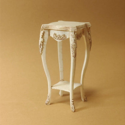 This Miniature Artisan Flower Stand Plant Shelf Side Table Kit for Dollhouses is a versatile and elegant addition to any dollhouse setting. Designed with intricate carvings and gracefully curved legs, this piece serves as a charming flower stand, a practical plant shelf, or a stylish side table. Its timeless vintage aesthetic makes it ideal for dollhouse living rooms, gardens, patios, or entryways.