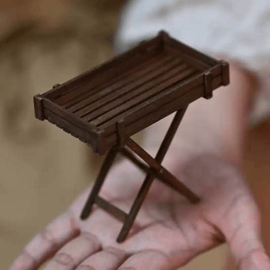 Add a touch of rustic charm to your dollhouse with this Miniature Folding Wooden Table Kit. Perfect for small spaces or as a decorative piece, this table features a detailed wooden construction with a folding design, allowing it to be compact and practical for any miniature setting. Whether you're using it as a plant stand, a side table, or a display piece, this table brings both functionality and style to your miniature world.