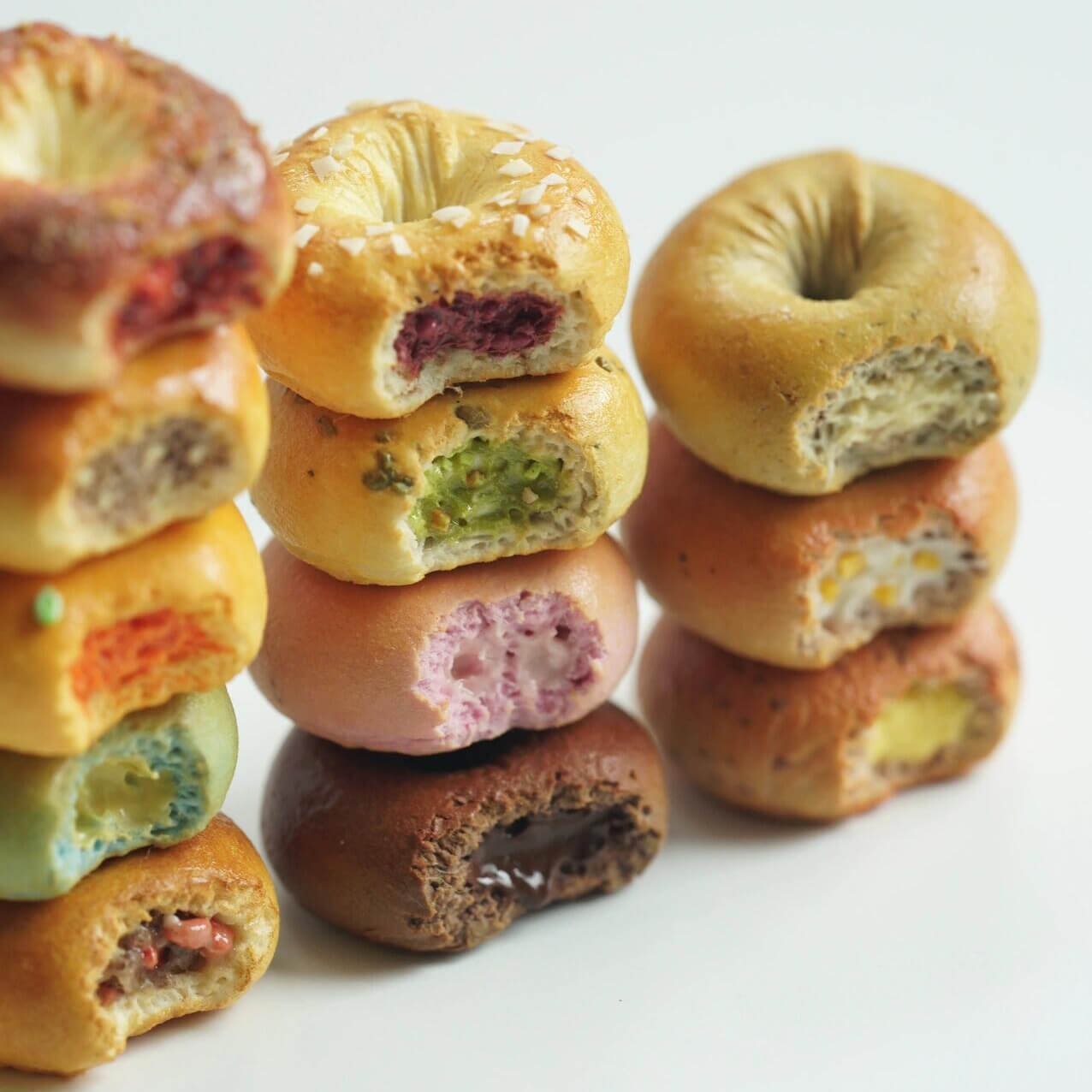 Each bagel with a bite missing perfectly crafted with realistic textures. Each bagel reveals their colorful, detailed interiors, making them look irresistibly lifelike.