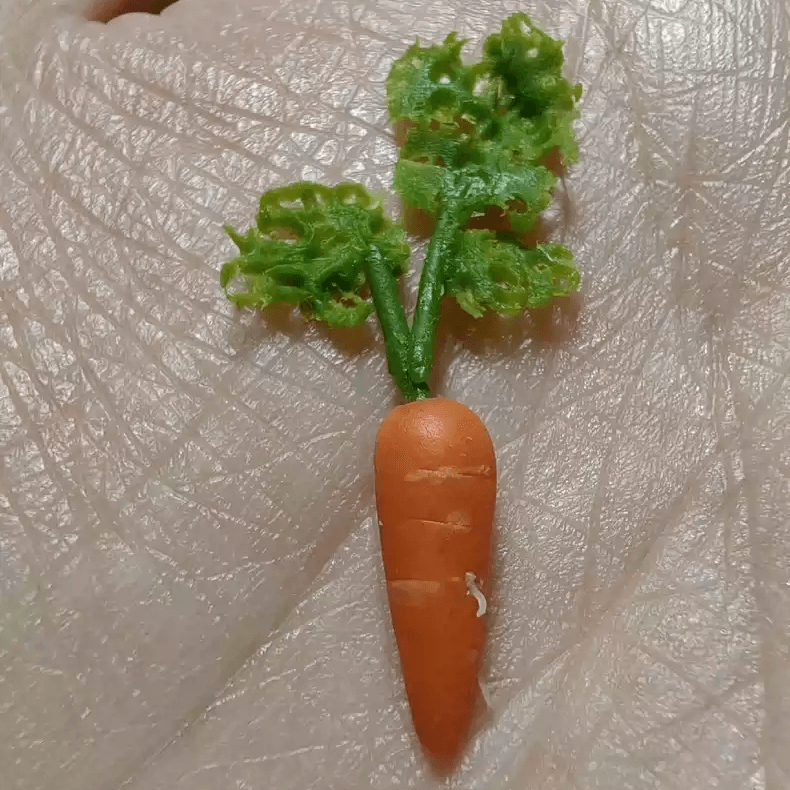 This miniature vegetable carrots would be a wonderful addition to any doll's house kitchen or dining room table. Material: Clay