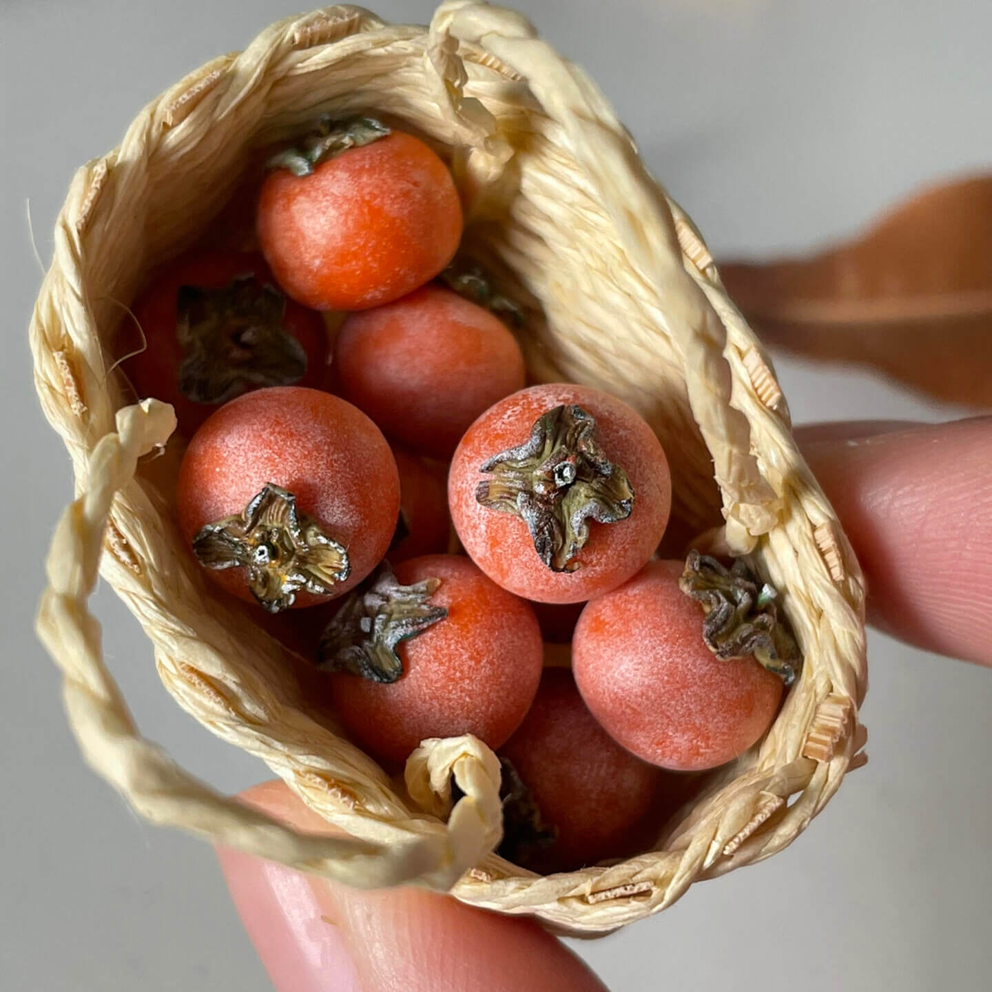 Miniature fruit persimmon for a dollhouse. Miniature fruit persimmon made of clay. Miniature fruit persimmon can be used in doll kitchen, doll grocery store, doll food, collection, diorama decoration.