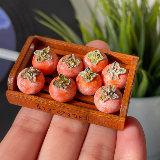 Miniature fruit persimmon for a dollhouse. Miniature fruit persimmon made of clay. Miniature fruit persimmon can be used in doll kitchen, doll grocery store, doll food, collection, diorama decoration.