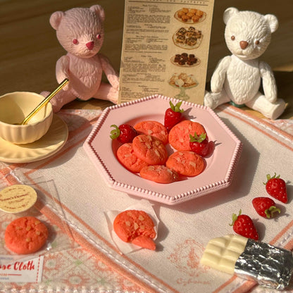 The set includes: 2 placemats, 1 plate, 8 strawberry cookies, 1 coffee cup set, 6 strawberries, and 1 white chocolate. The bear is not included. Material: Clay