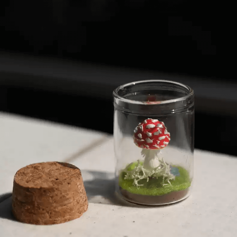 Bring a touch of magic to your space with our adorable Miniature Mushroom nestled in a charming glass jar! This enchanting piece creating a serene atmosphere perfect for any dollhouse room or garden.