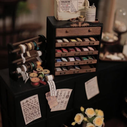 Miniature Jewelry Box Spool Cabinet is an excellent separation to keep your beloved dollhouse jewelry organized and secured. Its attractive appearance and large capacity make it a good collection helper that can hold different types of jewelry. Default Color/ Finish: Black and Brown Style: Shabby Chic Material: Wood