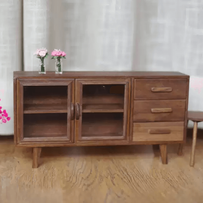 This Miniature Modern Wood Buffet Sideboard Cabinet with Doors and Drawers is ideal for storing dollhouse dinnerware and other items. Made of Black Walnut wood or Cherry wood, it offers a sophisticated and durable storage solution. The doors adds a touch of elegance and allows for a glimpse of the contents inside.