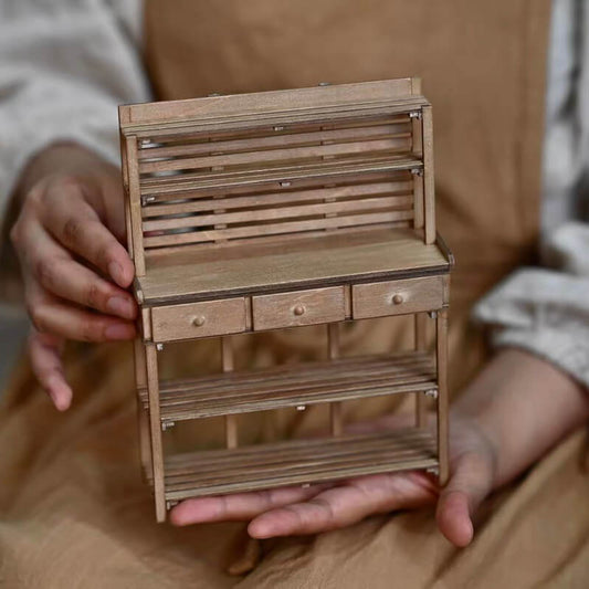 This miniature potting bench provides ample space for potting your dollhouse plants. A practical way to prepare your plants at worktop height helping to keep mess to a minimum. Default Color/ Finish: Brown Material: Wood Scale: 1/6 (14.4×4.2×18.7cm / 5.67×1.65×7.36in)