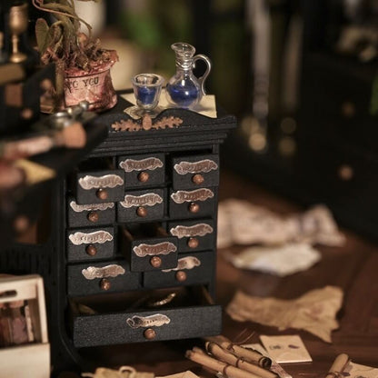 Add a charming and functional touch to your dollhouse kitchen with this Miniature Vintage Spice Cabinet with Drawers Kit. This beautifully crafted cabinet features multiple small drawers, perfect for storing spices, herbs, or other tiny kitchen essentials. The elegant black finish, combined with detailed handles and decorative accents, gives it a nostalgic, vintage feel that will enhance the charm of any dollhouse kitchen.