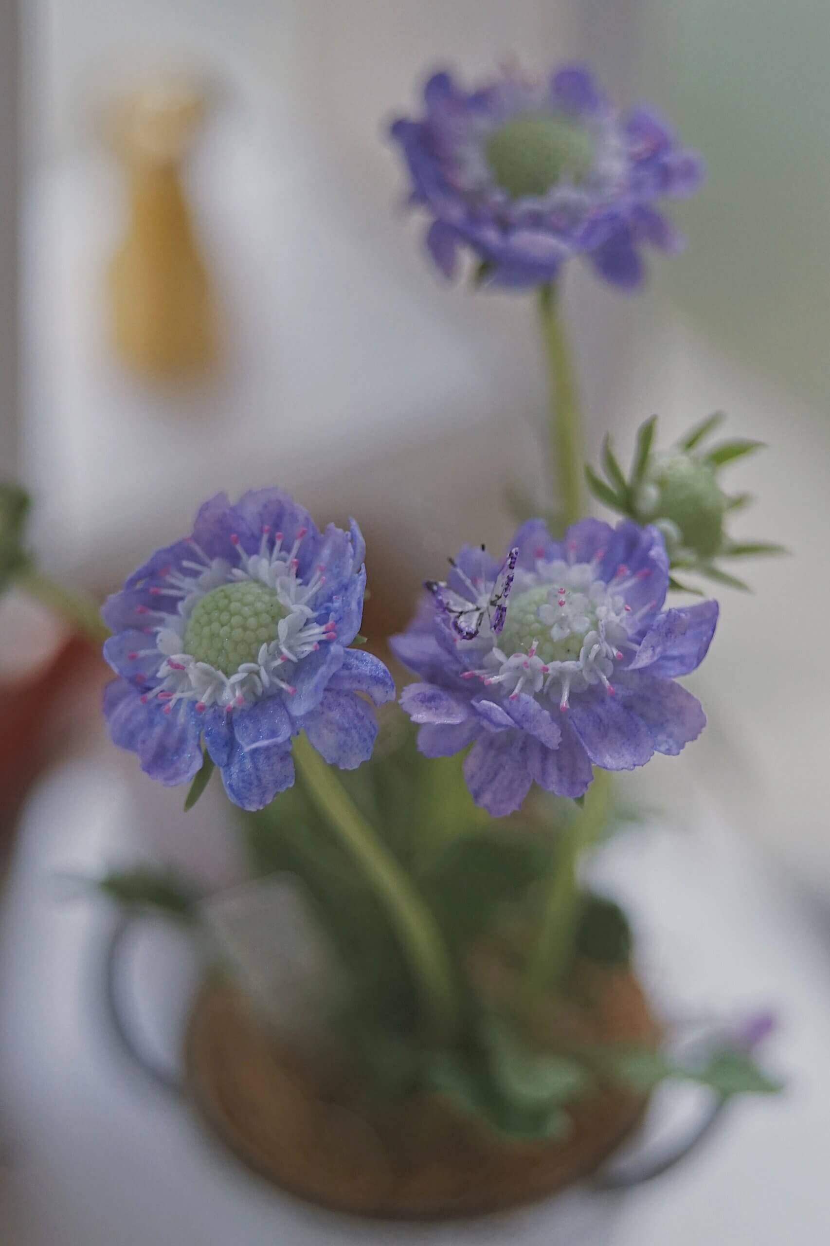 Scabiosa, also called pincushion flower, has a delicate appearance with whimsical, frilly skirts of petals and long, wiry stems—perfect for cutting and arranging in bouquets.  Material: Handmade from Clay