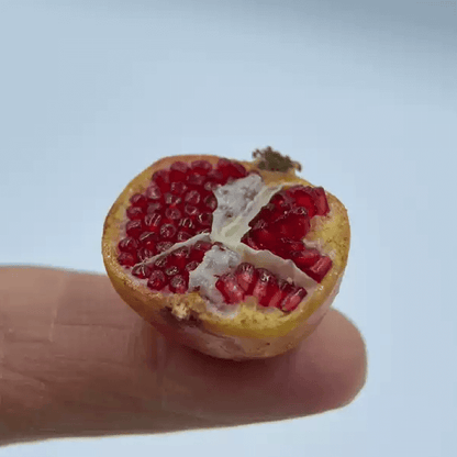 This miniature fruit pomegranate would be a wonderful addition to any doll's house kitchen or dining room table. Material: Polymer Clay This item contains one pomegranate, one opened pomegranate and some seeds.