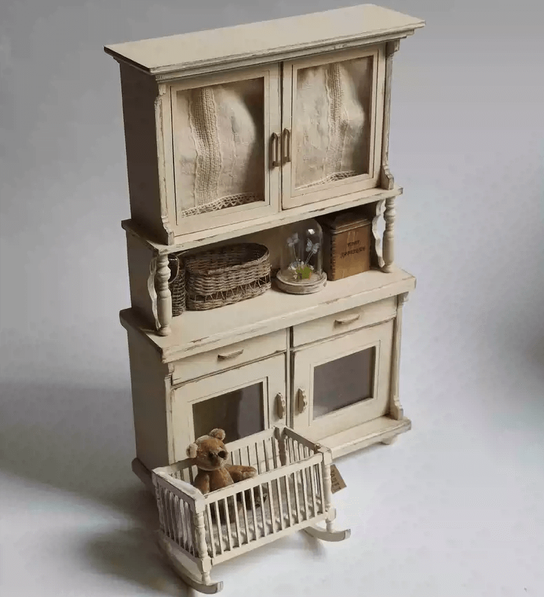 Add a touch of vintage elegance to your dollhouse with this Miniature Shabby Chic Kitchen Sideboard Cupboard Dresser Cabinet Kit. This beautifully crafted piece combines a charming sideboard with a cupboard and dresser, offering both display and storage options. The cabinet features doors for showcasing small items, while the lower section includes drawers for organizing your mini treasures.