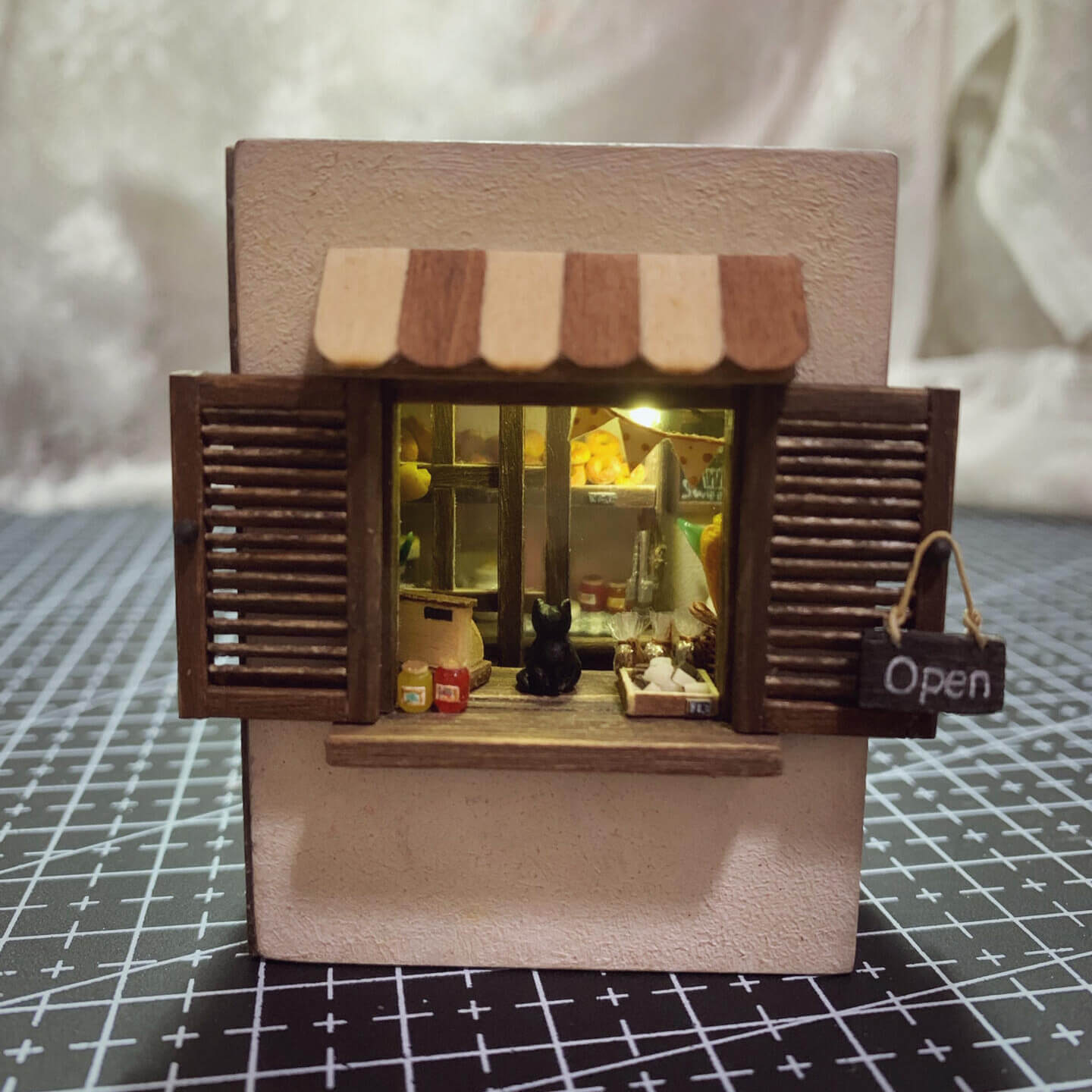 Inspired by "Kiki's Delivery Service" "I’m not quite sure of my direction, but I hope I can go a little further." — "Kiki's Delivery Service" Can be opened, flipped through, and has lights; all small items can be removed. Louvered windows and sliding doors.