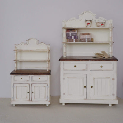 Bring rustic charm to your dollhouse kitchen with this Miniature Vintage Kitchen Hutch Cabinet Kit. This beautifully crafted kit includes a spacious upper shelf for displaying small items, along with a lower section featuring storage drawers and cupboards for organizing kitchen essentials. The charming white finish with intricate detailing and elegant design makes it a perfect addition to any miniature kitchen, dining room, or country-style space.