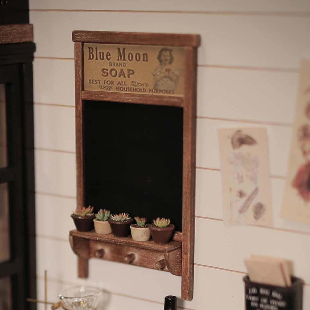 Corral the dollhouse keys, plants and other countertop clutter with this handy miniature Wall Organizer, complete with a chalkboard and hooks. Default Color/ Finish: Black and Brown Style: Shabby Chic Material: Wood Scale: 1/6 (6×10.7cm / 2.36×4.21in)