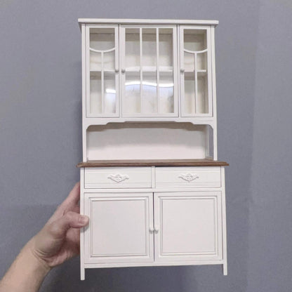 Elegantly appointed, the White Kitchen Dresser is a fantastic way to add plenty of extra storage space to any 1/6 scale dollhouse kitchen or dining room. Color/ Finish: White Styles: French styling Material: Solid Wood Type: Kitchen Dresser, Kitchen Cabinet. Miniature Furniture for 1/6 scale dolls, dollhouse, Kitchen.