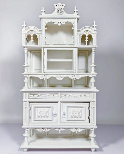 Enhance your dollhouse dining area with this Miniature Antique Buffet Cabinet with Carved and Shelves Kit. This beautifully crafted buffet features both open shelves for displaying miniatures and closed compartments for storage, all adorned with intricately carved decorative details and an elegant design. Available in various sizes, this buffet is perfect for showcasing fine dining accessories, storing dishes, or adding a sophisticated, vintage touch to your miniature kitchen or dining room.