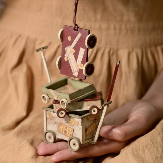 Bring a whimsical and vintage charm to your dollhouse or miniature collection with this miniature toy cart kit. Perfect for adding a unique storage or display piece, this kit allows you to assemble and customize your own toy cart.