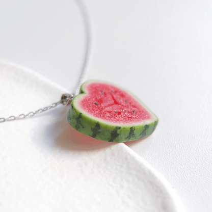 Cute realistic heart shaped watermelon slice necklace with sterling silver chain. The watermelon are made with polymer clay and then finished with a gloss varnish. The necklace are made from high-quality materials and are durable, but should not be put in aggressive environments like excessive moisture, chemicals or perfume.