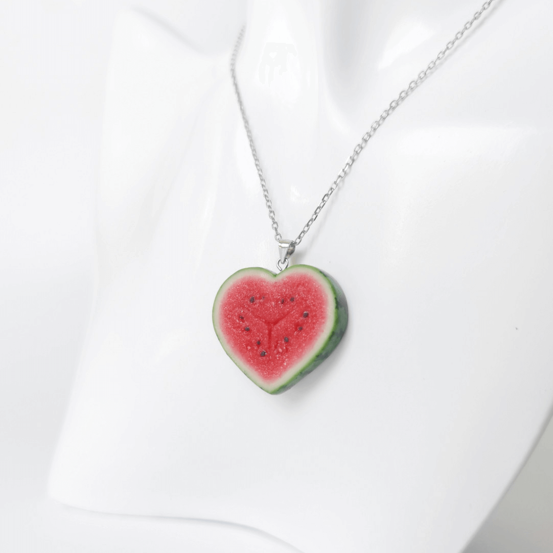 Cute realistic heart shaped watermelon slice necklace with sterling silver chain. The watermelon are made with polymer clay and then finished with a gloss varnish. The necklace are made from high-quality materials and are durable, but should not be put in aggressive environments like excessive moisture, chemicals or perfume.